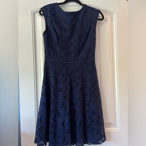 Navy blue, knee length sleeveless dress.